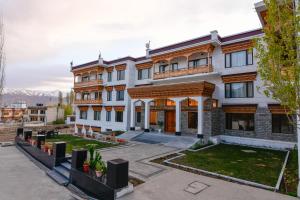 an apartment building with a courtyard with plants at Hotel Barath Ladakh in Leh