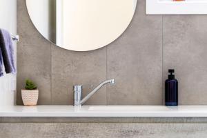 bagno con lavandino e grande specchio di Taylors Beach Cottage a Taylors Beach Altre 13 foto