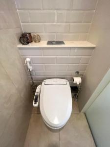 a bathroom with a white toilet in a room at 2 Bedroom Luxury Apartment 3 min walk from BTS Ekkamai in Bangkok