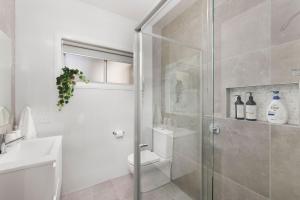 a bathroom with a shower with a toilet and a sink at Comfort Luxury and Surrounded by Popular Beaches in Boat Harbour +15 photos