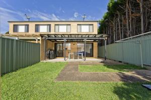 a house with a fence in front of a yard at Close to Little Beach and Shoal Bay Beach in Nelson Bay