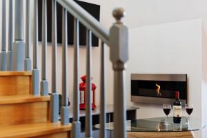 a staircase with a glass table and two glasses of wine at Apartament Pardałówka Prestige in Zakopane