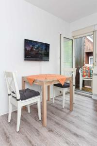 TV a/nebo společenská místnost v ubytování Haus Flinthoern