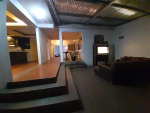 a living room with a couch and a television at Casa Elenita in San Juan La Laguna