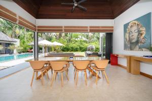 an open kitchen and dining room with a table and chairs at Luxury 3BR Villa C Layan Estate: Idyllic Retreat near Beach in Layan Beach