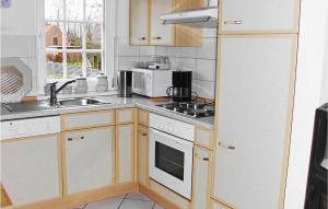 a kitchen with a sink and a stove top oven at 3 Bedroom Gorgeous Apartment In Altenmedingen in Altenmedingen
