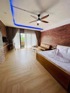 a bedroom with a bed and a brick wall at Hoi An Golden Bamboo An Bang Beach Villa & Spa in Hoi An