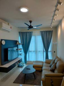 a living room with a couch and a ceiling fan at Da Best Guesthouse One Maxim Sentul Nice Cozy Condo 3 Rooms Aircond in Sentul KL in Kuala Lumpur