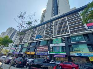 a large building with cars parked in front of it at Da Best Guesthouse One Maxim Sentul Nice Cozy Condo 3 Rooms Aircond in Sentul KL in Kuala Lumpur