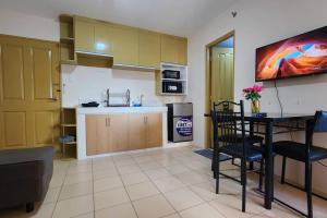 a kitchen with a table and chairs in a room at Denise's Midtown Condo in Davao City