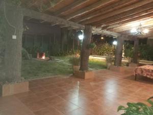 a patio with a fireplace in a yard at night at Casa de campo in Rodeo del Medio +6 photos