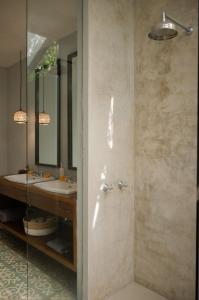 a bathroom with two sinks and a shower at The Bed by The Sea in Canggu