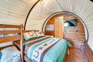 a bedroom with a bed in a tent at Ultimate Covered Wagon Pioneers Paradise in Brownsville