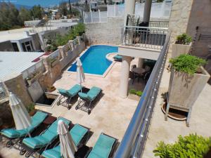 an overhead view of a pool with chairs and umbrellas at Truffle Residences in Kalkan