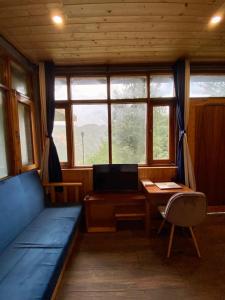 a room with a bed and a desk with a computer at Lacasa Luxury Stays in Shogi