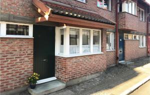 a brick house with a black door and a window at Nice Home In Ystad With 4 Bedrooms And Wifi in Ystad