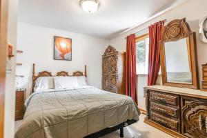 a bedroom with a bed and a mirror and a dresser at Blissful Retreat in Wisconsin Rapids in Wisconsin Rapids