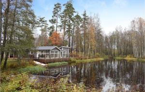 a house in the middle of a lake at Amazing Home In Ryssby With 1 Bedrooms, Sauna And Wifi in Hörda