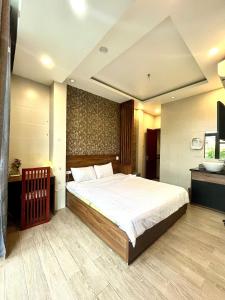 a bedroom with a large bed in a room at Shine Hotel in Hue