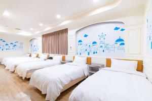 Postel nebo postele na pokoji v ubytování 柜富賓王旅店-台北館 Giant Rich King Plaza Hotel