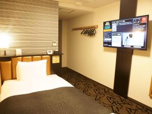 A bed or beds in a room at APA Hotel Saitama Yatsuka Ekimae