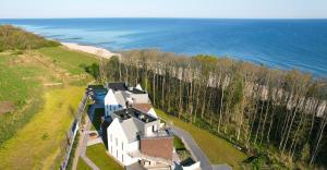 an aerial view of a house next to the ocean at CLIFF Trzęsacz - sea view apartments in Trzęsacz
