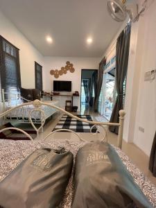 a bedroom with a bed and a living room at ComeHome Lamphun in Lamphun