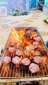 a grill with meat cooking on top of it at Thien Phu Homestay and Coffee - Mang Den in Kon Von Kla