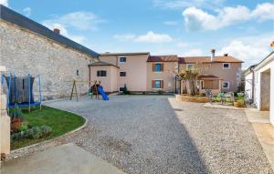 a gravel driveway with a playground in a house at 3 Bedroom Cozy Home In Svetvincenat in Svetvinčenat