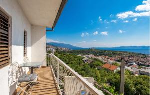 a balcony with a table and chairs and a view at Nice Apartment In Senj With 2 Bedrooms And Wifi in Senj