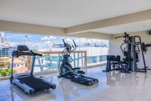 a gym with cardio equipment and a large window at Water Park Condominium in Pattaya South