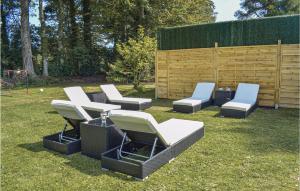 a group of chairs and tables on the grass at Gorgeous Home In St-Martin-Aux-Buneaux in Saint-Martin-aux-Buneaux +34 photos