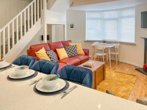 a living room with a couch and a table at Robins Nest in Edwinstowe