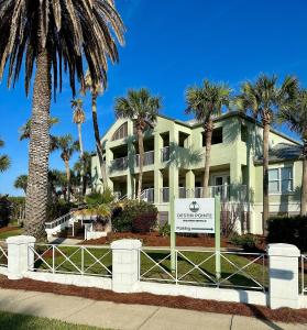 a large house with palm trees in front of it at Southern Nights At Destin Pointe Resort in Destin