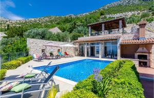 a villa with a swimming pool and a house at Beautiful Home In Trsteno With Wifi in Trsteno