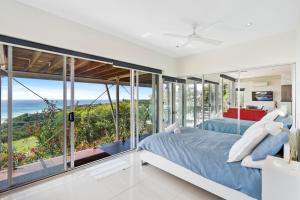a bedroom with a view of the ocean at Allure in Point Lookout