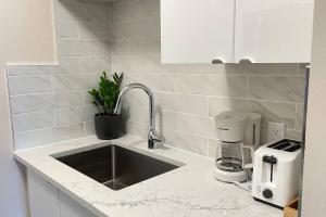 a kitchen counter with a sink and a coffee maker at unit #303 Mountain view 1BR in Canmore DownTown in Canmore +8 photos