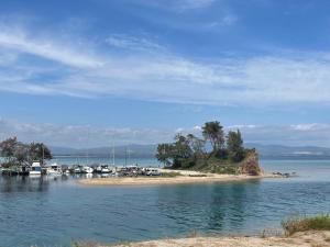 a group of boats docked on a small island in the water at Ntina's Room in Nea Potidaea