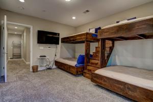 a bedroom with two bunk beds and a television at Tahoe Woods Hideout in South Lake Tahoe