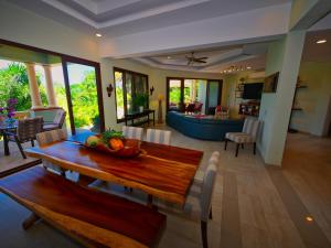 a dining room and living room with a table and chairs at Casa Lynda - 3 Bedrooms in West Bay