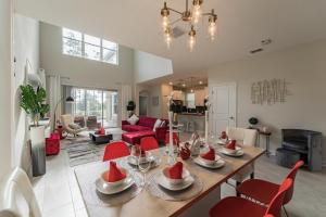 a dining room and living room with a table and chairs at Ruby Falls Villa in Kissimmee