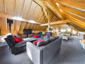 a living room with couches and a flat screen tv at Stunning Log Cabin With A Pool Table For Hire In Norfolk, Sleeps 8 Ref 34045al in King's Lynn