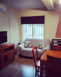 - un salon avec un canapé et une fenêtre dans l'établissement EL RINCON DE ANGELA, à Cordoue