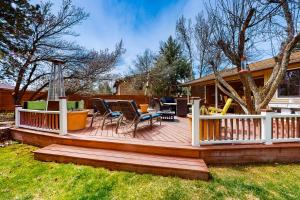 a wooden deck with chairs and tables on a house at Crown Mountain Retreat in Carbondale