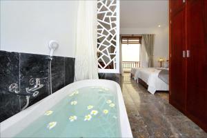 Voodi või voodid majutusasutuse Hoi An TNT Villa toas