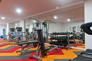 a gym with lots of equipment in a room at Four bedroom apartment with facilities in Olympic Park in Sydney