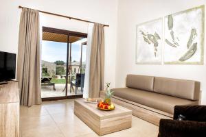 
a living room filled with furniture and a large window at Hotel Son Trobat Wellness & Spa in Sant Llorenç des Cardassar

