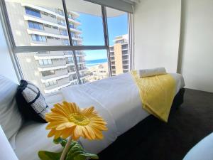 a bed in a room with a large window at Ocean View 2BR Main Beach Getaway in Gold Coast