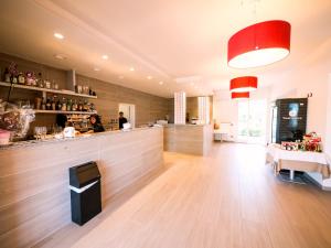 a restaurant with a counter and a bar in a room at Pomposa Residence in Lido di Pomposa