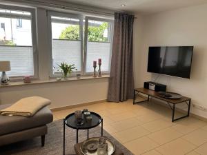 Televisyen dan/atau pusat hiburan di schöne Ferienwohnung 2,5 Zimmer in Stadtnähe mit eigenem Hofgarten
